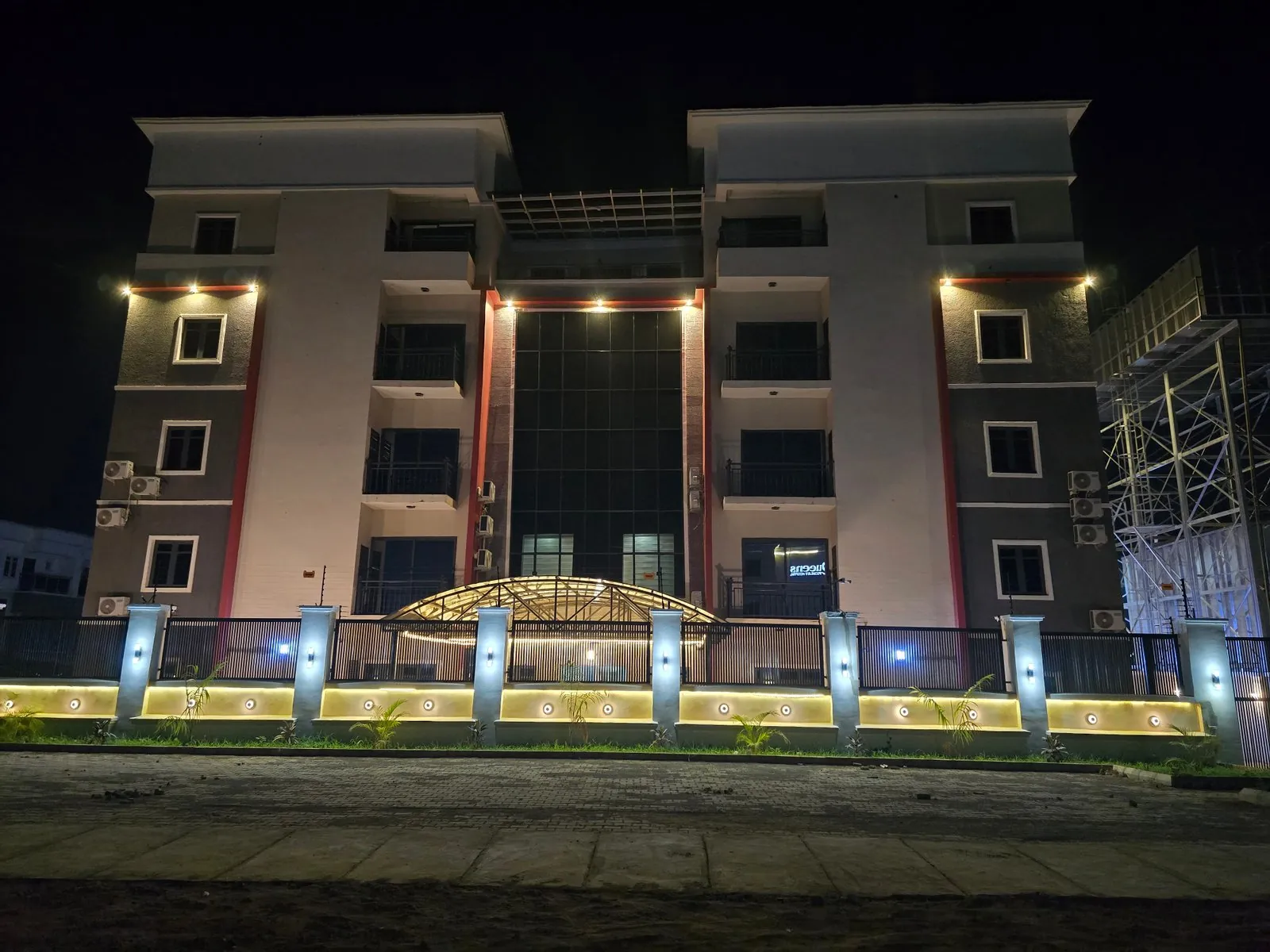 Four-storey Prestine Apartments building on Martin Ejembi Crescent, Apo, Abuja, lit up at night